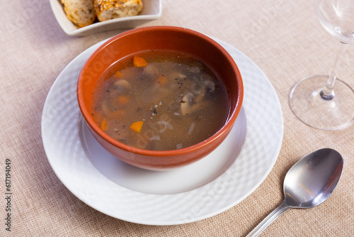 Pork soup with mushrooms cooked with pearl barley, carrots and spices