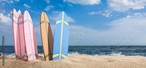 Many surfboards on beach sand