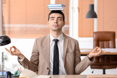 Young businessman with book...