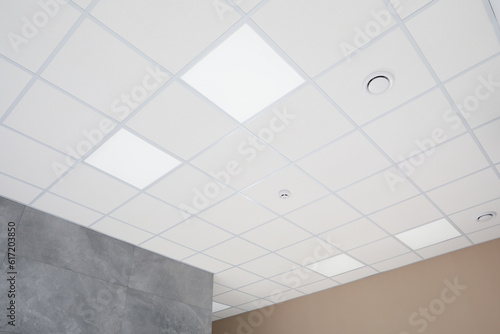 White ceiling with modern lighting in room, low angle view photo