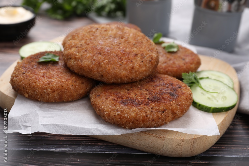 Tasty vegan cutlets served on wooden table, closeup Tasty vegan cutlets served on wooden table, closeup