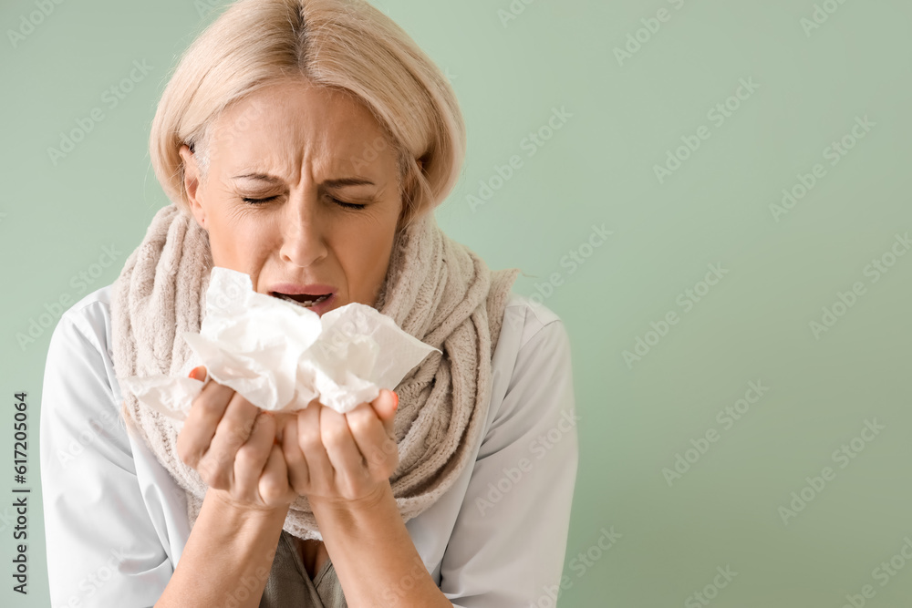 Ill mature woman with tissues on green background, closeup Ill mature woman with tissues on green background, closeup