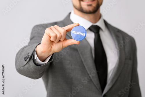 Male volunteer with badge o...
