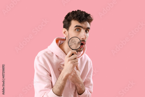 Shocked young man with magn...