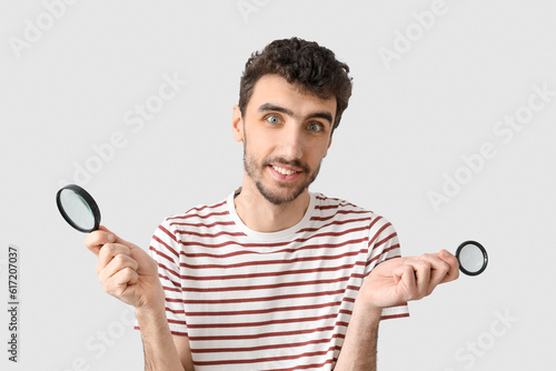 Young man with magnifiers o...