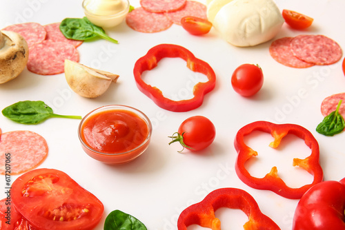 Fresh ingredients for preparing pizza on white background