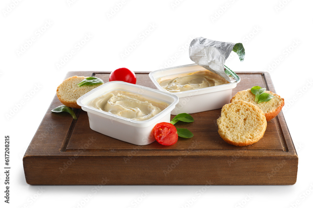 Plastic containers with tasty cream cheese on white background