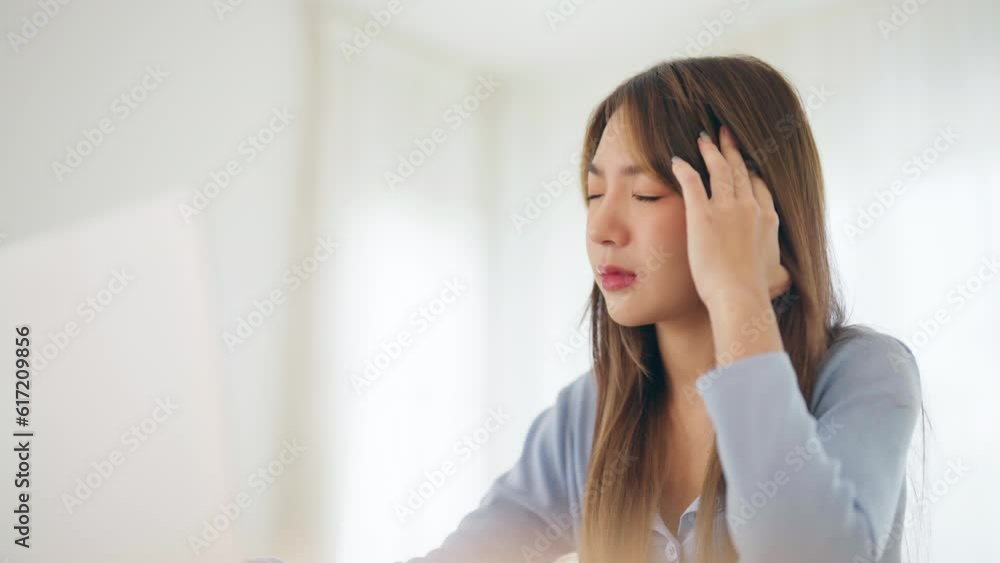 Office syndrome. Overworked tired young asian woman feeling headache, having eyesight problem after computer laptop work. Stressed young woman suffering from fatigue at home Office syndrome. Overworked tired young asian woman feeling headache, having eyesight problem after computer laptop work. Stressed young woman suffering from fatigue at home