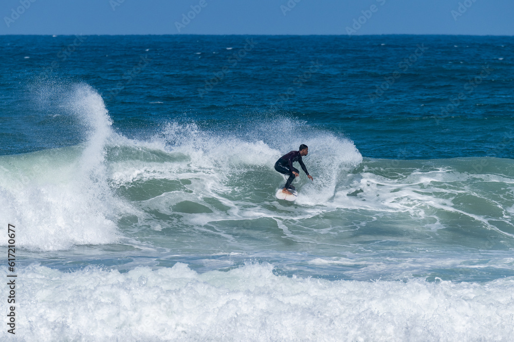 Surfer riding waves in Furadouro Beach