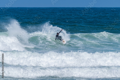 Surfer riding waves in Furadouro Beach