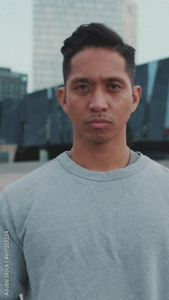 Young man crossing his arms and looking at the camera Young man crossing his arms and looking at the camera