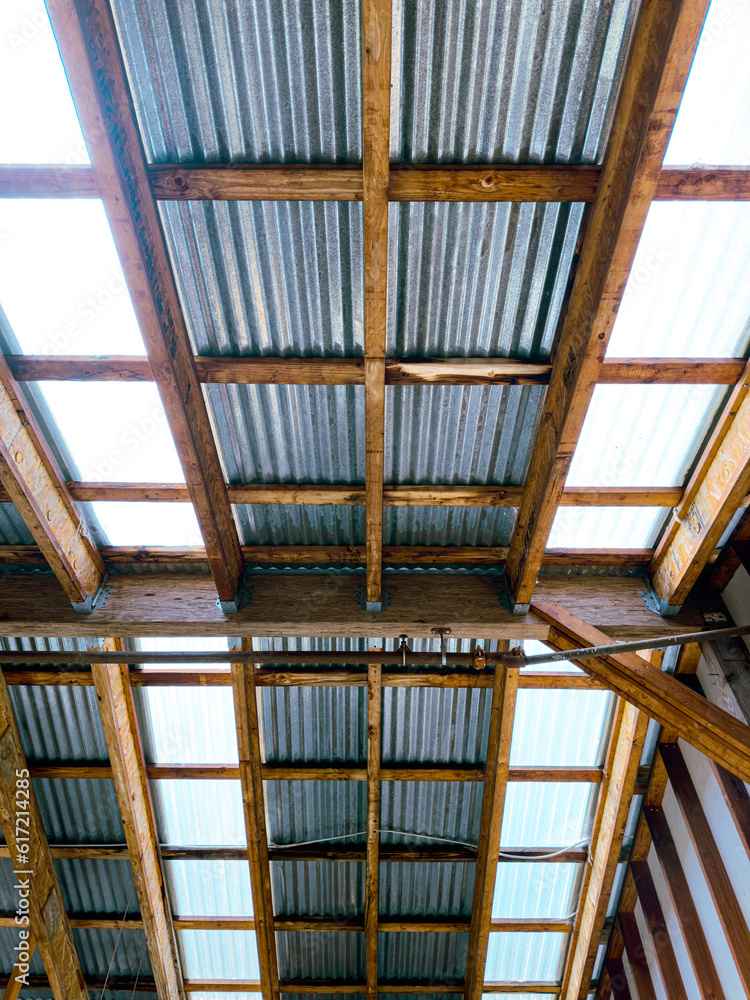 Obraz premium rafters ceiling light machine shop workshop factory roof corrugated beams shed metal tin wood beams