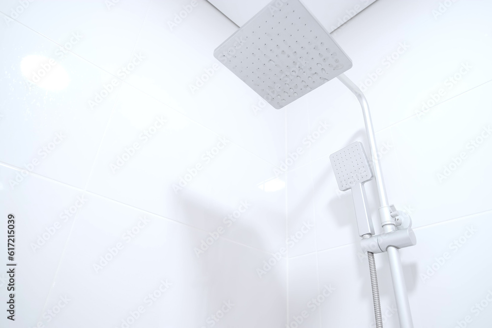 Modern rain shower faucet design. Bathroom. White tiles on the wall. Stylish bright bathroom Modern rain shower faucet design. Bathroom. White tiles on the wall. Stylish bright bathroom