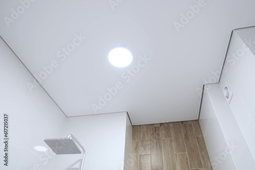 White stretch ceiling in a stylish bright bathroom. Modern design photo