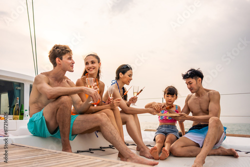 Group of diverse friends eating barbecue while having a party in yacht.  © Kawee