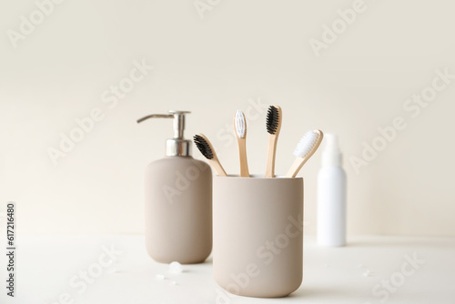 Bamboo tooth brushes in holder on light background