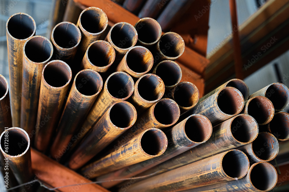 Stack of rusty cold rolled tubes in industrial complex storage Stack of rusty cold rolled tubes in industrial complex storage