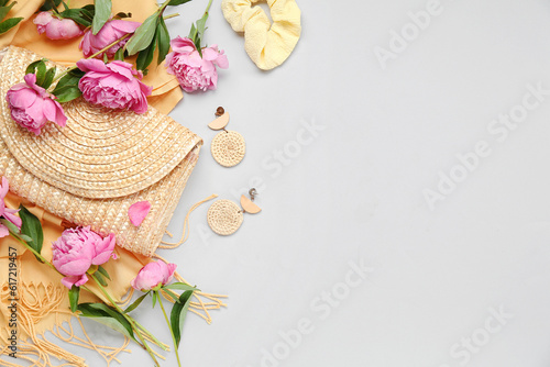 Composition with stylish female accessories and beautiful peony flowers on light background