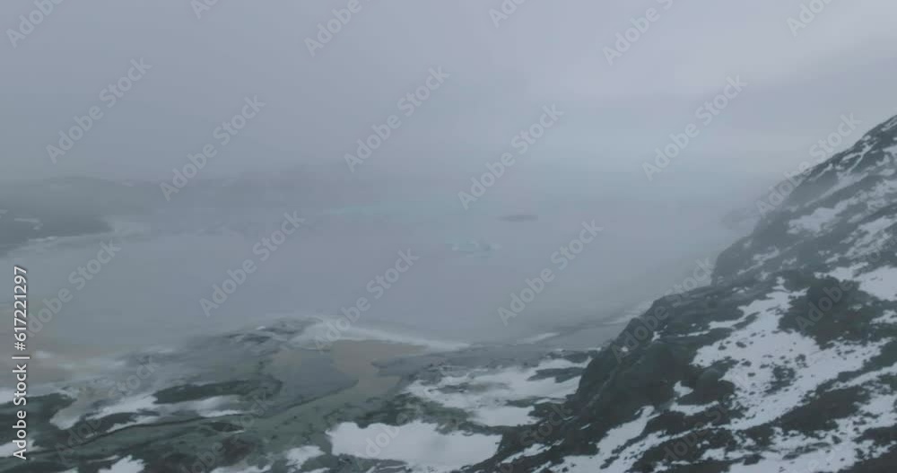 Drone Shot of Man on Lookout Above Frozen Glacial Lake and Glacier in Landscape of Iceland, 50fps Drone Shot of Man on Lookout Above Frozen Glacial Lake and Glacier in Landscape of Iceland, 50fps
