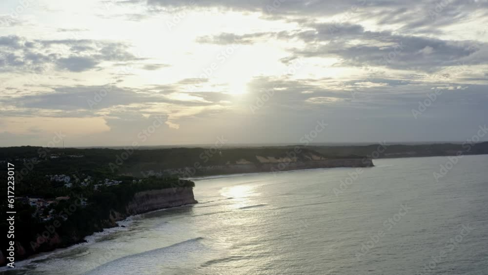 Dolly in aerial drone wide landscape shot of the stunning tropical Northeastern Brazil coastline from Pipa, Rio Grande do Norte with large clay cliffs during a warm sunny overcast evening Dolly in aerial drone wide landscape shot of the stunning tropical Northeastern Brazil coastline from Pipa, Rio Grande do Norte with large clay cliffs during a warm sunny overcast evening