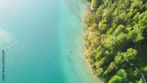 Incredible aerial bird's eye view of emerald green lake water in Austria photo