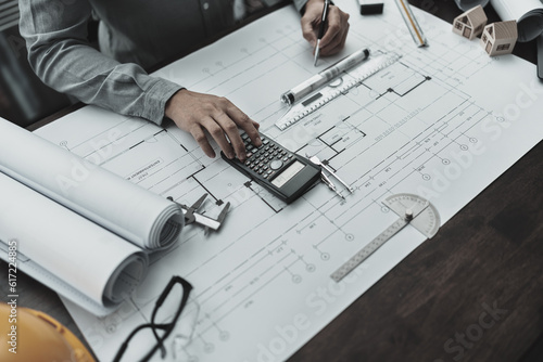 Engineering working with drawings inspection and press calculator on Blueprint. Engineer, Architect, Industry and factory concept.