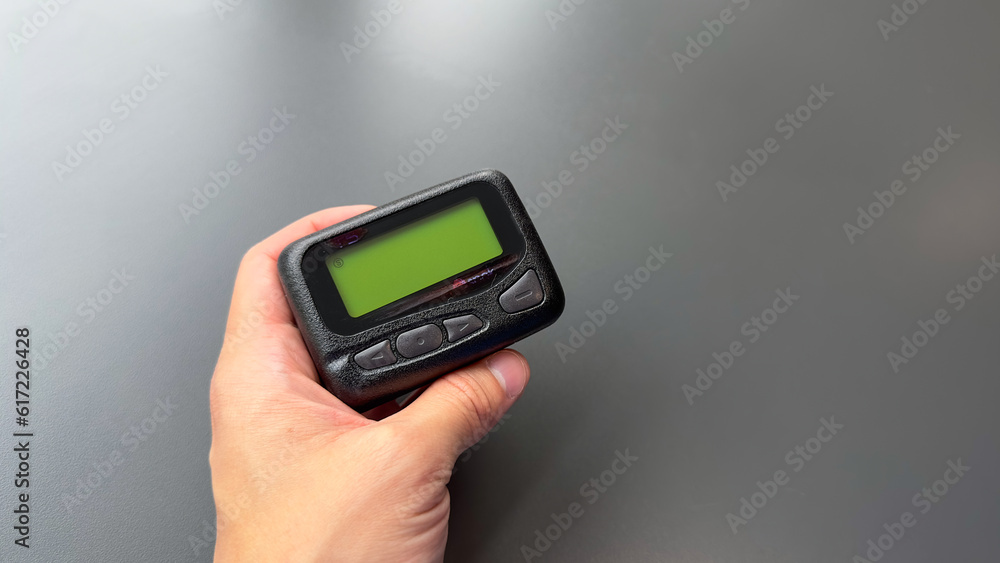 pager beeper device rests on a desk, representing the power of instant communication, connectivity, and the evolution of technology pager beeper device rests on a desk, representing the power of instant communication, connectivity, and the evolution of technology