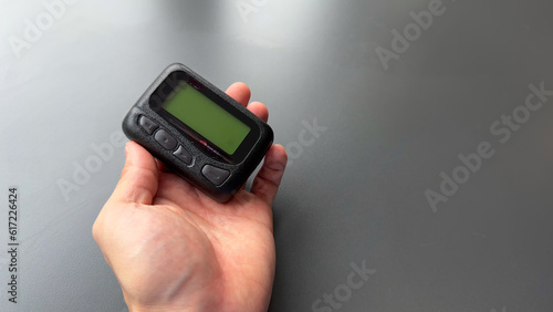 pager beeper device rests on a desk, representing the power of instant communication, connectivity, and the evolution of technology
