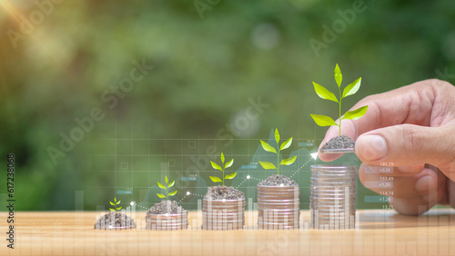 Φωτογραφία Hands laying coins on pile with plant growing money with investment concept green background Raise funds to support green environmentally friendly projects, saving money