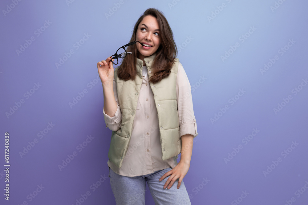 young lady brunette in casual took off her glasses from her face during a break in the office