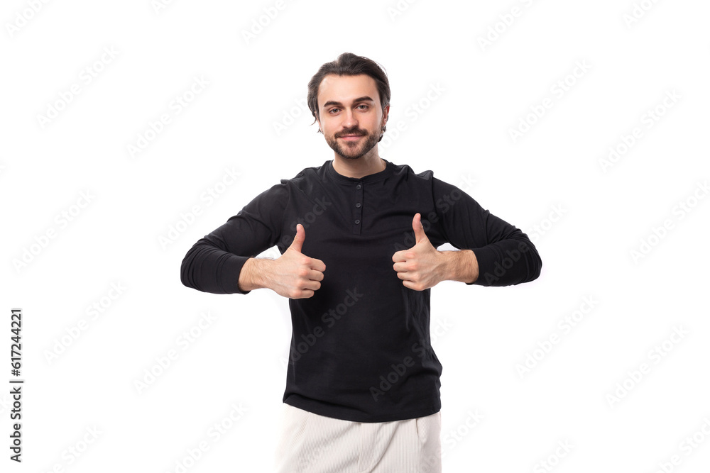 Fototapeta premium young handsome brunet european man in black sweatshirt with mockup on isolated white background