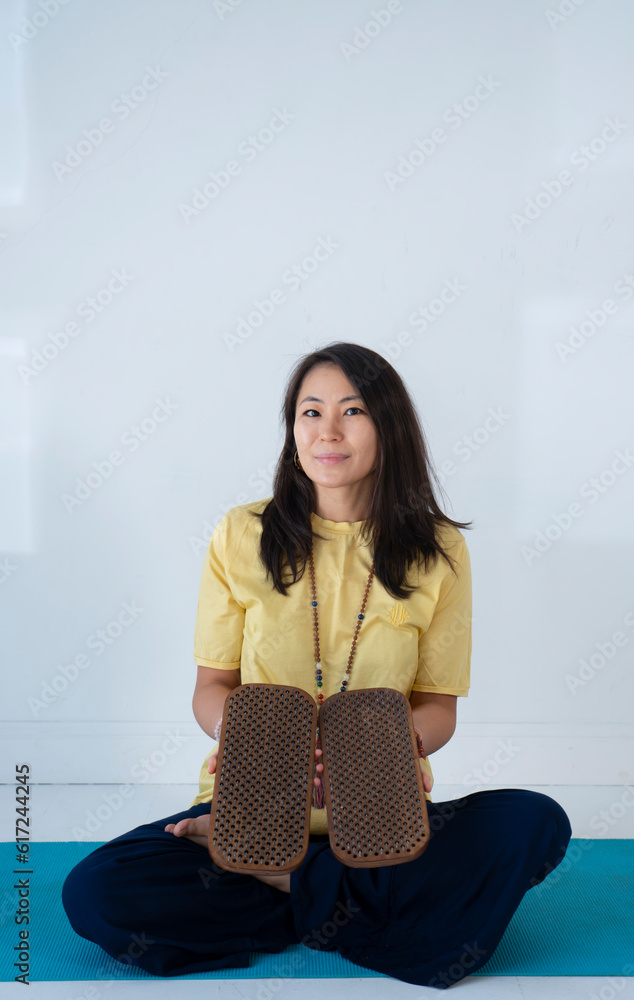 A young Asian woman stands on boards with nails (Sadhu). Nail session. A young Asian woman stands on boards with nails (Sadhu). Nail session.