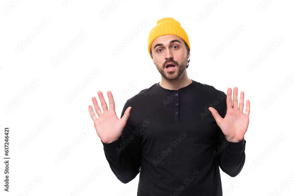 young brutal caucasian brunette man with a beard in a casual sweatshirt tired young brutal caucasian brunette man with a beard in a casual sweatshirt tired