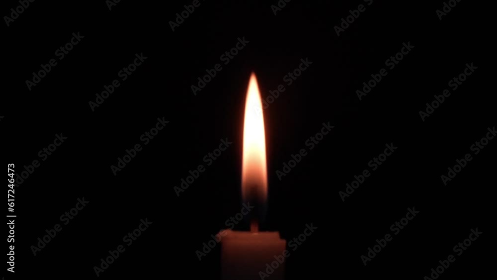 candles burning in the dark, with minimal light reflections candles burning in the dark, with minimal light reflections