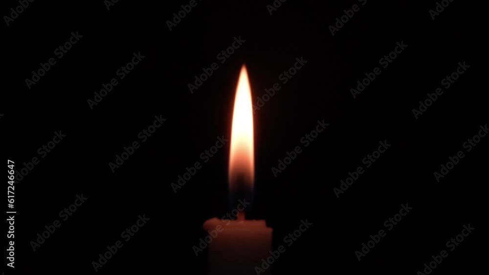 candles burning in the dark, with minimal light reflections candles burning in the dark, with minimal light reflections