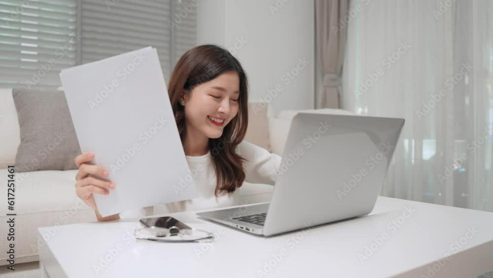 Asian business woman working and checking detail of document by laptop computer at home. Freelancer Asia female making to order from customer at home office store. Asian business woman working and checking detail of document by laptop computer at home. Freelancer Asia female making to order from customer at home office store.