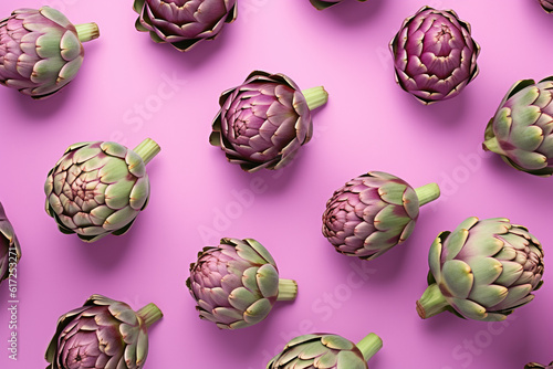 Top view of artichoke vegetables on pastel violet background photo