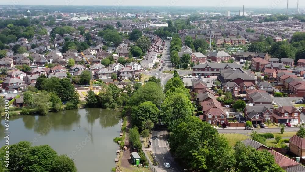 Establishing aerial view zoom in towards detached neighbourhood property and lakeside red brick British townhouse building site Establishing aerial view zoom in towards detached neighbourhood property and lakeside red brick British townhouse building site