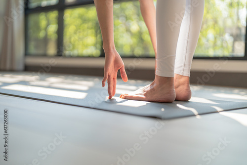 Female happiness Attractive young asian woman doing yoga stretching exercise on mat yoga & fitness exercises. Healthy lifestyle Calmness and relax at home.