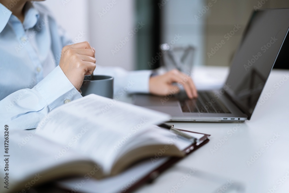 Asian Woman working by using a laptop computer Hands typing on keyboard. Working at office professional investor working new start up project Asian Woman working by using a laptop computer Hands typing on keyboard. Working at office professional investor working new start up project