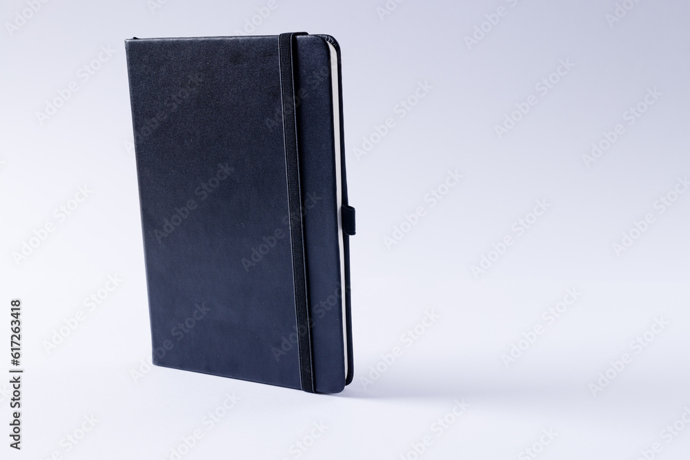 Close up of black notebook with copy space on white background Close up of black notebook with copy space on white background