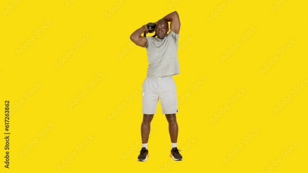 African man doing rotation nape exercises with kettlebell African man doing rotation nape exercises with kettlebell
