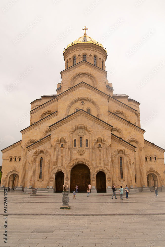 Tbilisi, Georgia - May 20, 2023 : Pedestrians walking around the Holy Trinity Cathedral of Tbilisi
