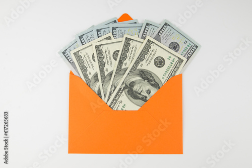 dollars in an orange envelope on white.