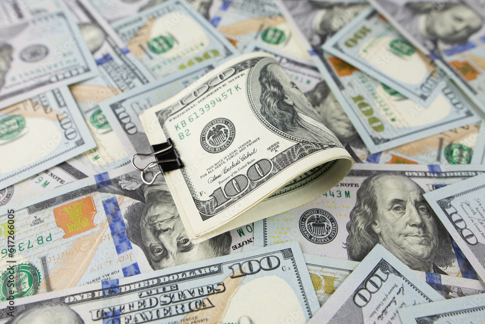 One hundred dollars close-up in large quantities lie on the table. Much money. One hundred dollars close-up in large quantities lie on the table. Much money.