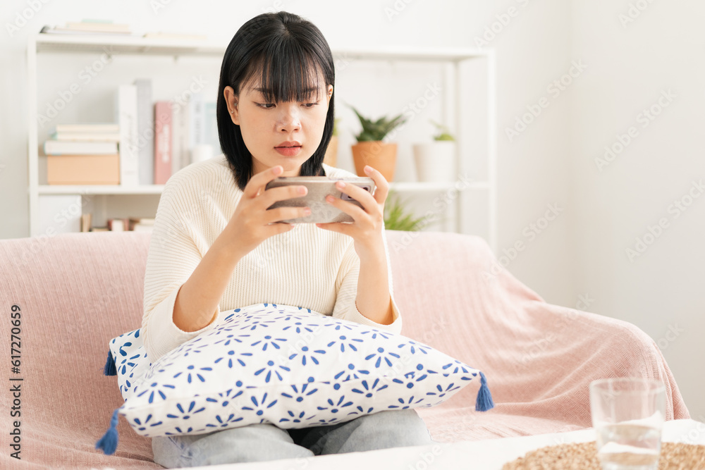 Asian woman play game online with live broadcasting via internet on smartphone. Asian woman play game online with live broadcasting via internet on smartphone.