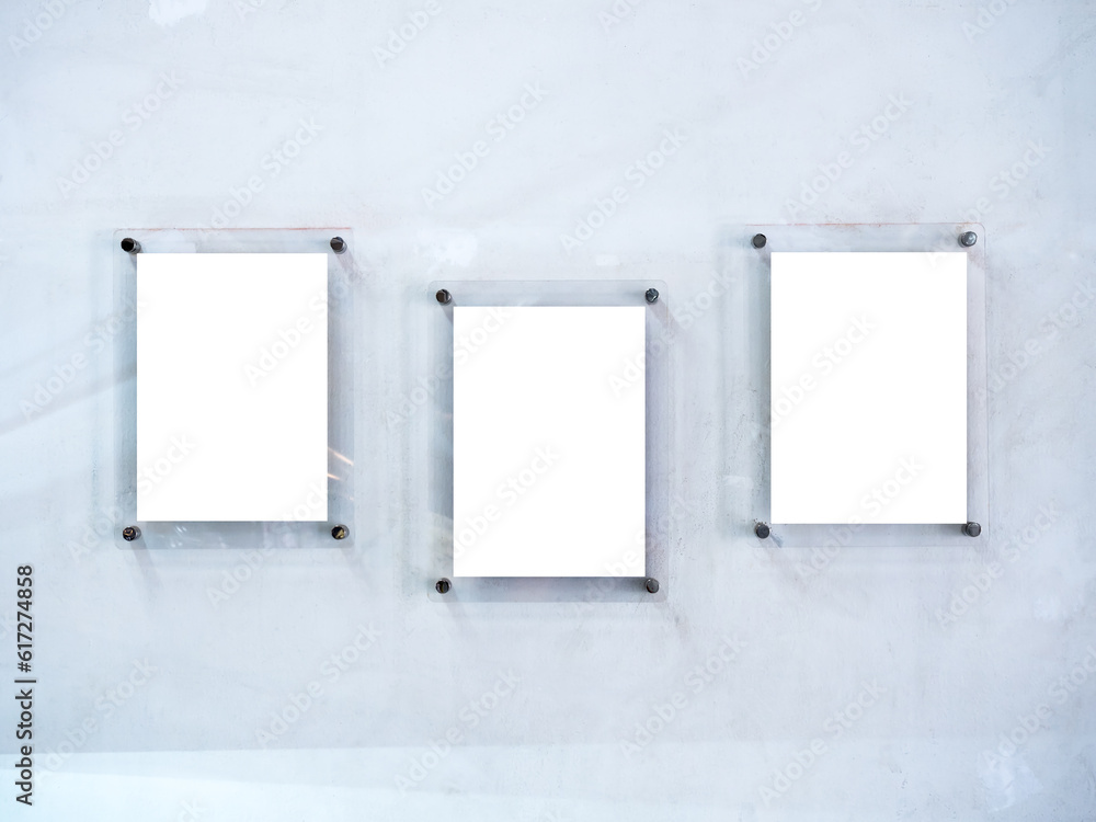 Three mockups of white blank paper poster or photo frames, acrylic materials, vertical style hanging on white dirty wall background. Three mockups of white blank paper poster or photo frames, acrylic materials, vertical style hanging on white dirty wall background.