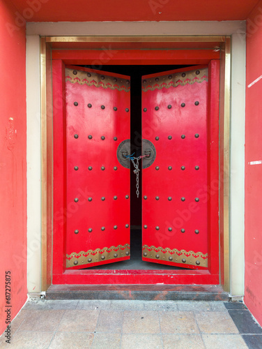 old Chinese wooden door with red wall
