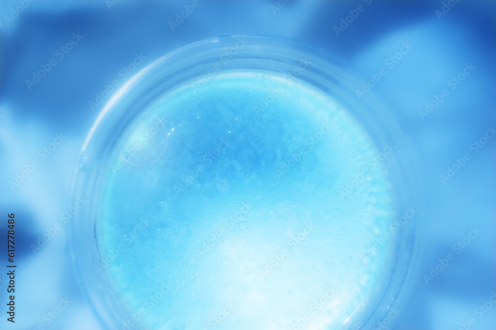 Abstract Defocus blue tiny water bubble in transparent plastic cup. Abstract premium blue backdrop banner for advertise commercial, cosmetic skincare and consumers products. Abstract Defocus blue tiny water bubble in transparent plastic cup. Abstract premium blue backdrop banner for advertise commercial, cosmetic skincare and consumers products.