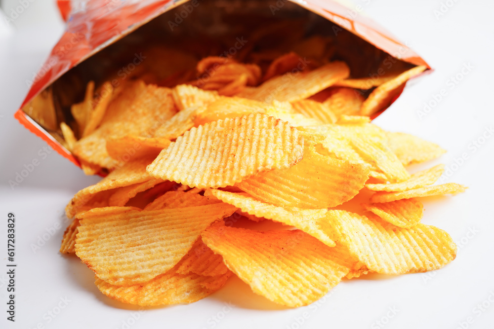 Potato chips in open bag, delicious BBQ seasoning spicy for crips, thin slice deep fried snack fast food. Potato chips in open bag, delicious BBQ seasoning spicy for crips, thin slice deep fried snack fast food.